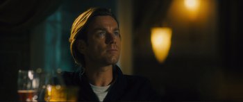 Movie still from “Our Kind of Traitor” (2016), directed by Susanna White – A person wearing a black shirt; Close Up shot, Low angle
