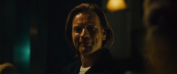 Movie still from “Our Kind of Traitor” (2016), directed by Susanna White – A person with long brown hair; Close Up shot, Low angle
