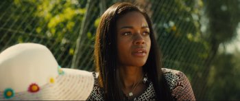 Movie still from “Our Kind of Traitor” (2016), directed by Susanna White – A person with long black hair; Close Up shot, Over the shoulder angle