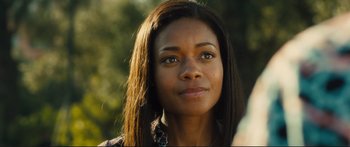 Movie still from “Our Kind of Traitor” (2016), directed by Susanna White – A person with long black hair; Close Up shot, Over the shoulder angle