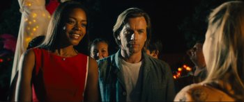Movie still from “Our Kind of Traitor” (2016), directed by Susanna White – A group of people standing next to each other in the dark; Close Up shot, Low angle