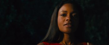 Movie still from “Our Kind of Traitor” (2016), directed by Susanna White – A person with long black hair; Close Up shot, Low angle