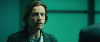 Movie still from “Our Kind of Traitor” (2016), directed by Susanna White – A person with long brown hair; Close Up shot, Over the shoulder angle
