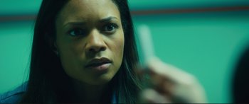 Movie still from “Our Kind of Traitor” (2016), directed by Susanna White – A person holding a cell phone; Close Up shot, Over the shoulder angle