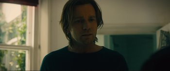 Movie still from “Our Kind of Traitor” (2016), directed by Susanna White – A person with long brown hair; Close Up shot, Over the shoulder angle