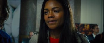 Movie still from “Our Kind of Traitor” (2016), directed by Susanna White – A person with long black hair; Close Up shot, Over the shoulder angle