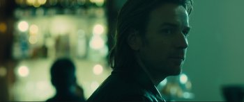 Movie still from “Our Kind of Traitor” (2016), directed by Susanna White – A person with long hair; Close Up shot, Over the shoulder angle