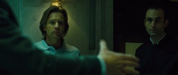 Movie still from “Our Kind of Traitor” (2016), directed by Susanna White – A man sitting in front of a mirror in a room; Close Up shot, Over the shoulder angle