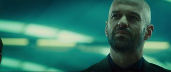 Movie still from “Our Kind of Traitor” (2016), directed by Susanna White – A man with a bald head looking up at the sky; Close Up shot, Low angle