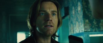 Movie still from “Our Kind of Traitor” (2016), directed by Susanna White – A person with long brown hair; Close Up shot, Low angle