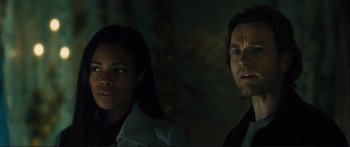 Movie still from “Our Kind of Traitor” (2016), directed by Susanna White – A man and a woman looking at something in the dark; Close Up shot, Low angle