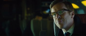 Movie still from “Our Kind of Traitor” (2016), directed by Susanna White – A person wearing glasses sitting in a car; Close Up shot, Low angle
