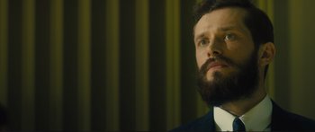 Movie still from “Our Kind of Traitor” (2016), directed by Susanna White – A man with a beard is looking up at the sky; Close Up shot, Low angle