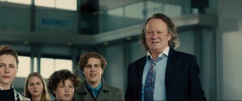 Movie still from “Our Kind of Traitor” (2016), directed by Susanna White – A man and two young boys standing next to each other; Medium shot, Low angle