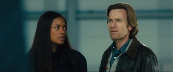 Movie still from “Our Kind of Traitor” (2016), directed by Susanna White – A man and a woman standing next to each other; Close Up shot, Over the shoulder angle