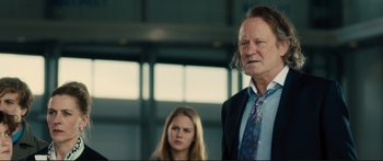 Movie still from “Our Kind of Traitor” (2016), directed by Susanna White – A man and a woman standing next to each other in front of a window; Close Up shot, Over the shoulder angle