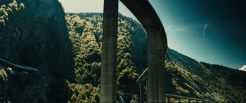 Movie still from “Our Kind of Traitor” (2016), directed by Susanna White – A view of a bridge and a forest from a bridge; Extreme Wide shot, High angle