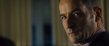 Movie still from “Our Kind of Traitor” (2016), directed by Susanna White – A man's face in a room; Close Up shot, Low angle