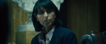 Movie still from “Our Kind of Traitor” (2016), directed by Susanna White – A woman in a business suit looking to her left; Close Up shot, High angle