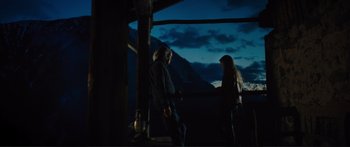 Movie still from “Our Kind of Traitor” (2016), directed by Susanna White – A man and a woman standing next to each other in front of mountains; Wide shot, Over the shoulder angle