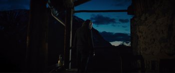 Movie still from “Our Kind of Traitor” (2016), directed by Susanna White – A man standing in the dark looking at the sky; Wide shot, Low angle