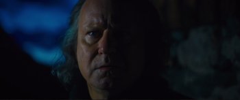 Movie still from “Our Kind of Traitor” (2016), directed by Susanna White – A person's face in the dark; Close Up shot, Over the shoulder angle