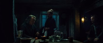 Movie still from “Our Kind of Traitor” (2016), directed by Susanna White – Two people sitting at a table with a bowl of fruit; Medium shot, Low angle