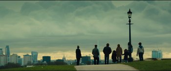 Movie still from “Our Kind of Traitor” (2016), directed by Susanna White – A group of people standing on top of a hill; Extreme Wide shot, Low angle