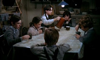 Movie still from “Our Mother's House” (1967), directed by Jack Clayton – A group of people sitting around a table; Medium shot, High angle