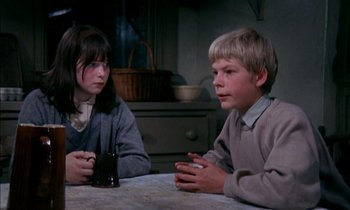 Movie still from “Our Mother's House” (1967), directed by Jack Clayton – A boy and a girl sitting at a table talking to each other; Medium shot, High angle