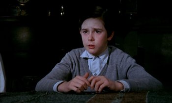 Movie still from “Our Mother's House” (1967), directed by Jack Clayton – A young boy sitting at a table in front of a window; Close Up shot, High angle