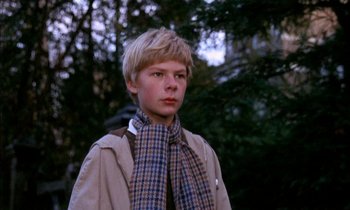 Movie still from “Our Mother's House” (1967), directed by Jack Clayton – A young man wearing a plaid scarf and a jacket; Close Up shot, Low angle
