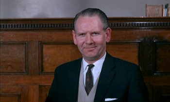 Movie still from “Our Mother's House” (1967), directed by Jack Clayton – A person wearing a suit and tie; Close Up shot, Low angle