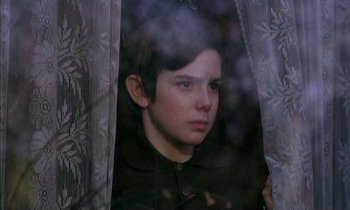 Movie still from “Our Mother's House” (1967), directed by Jack Clayton – A young boy looking out of a window at night; Close Up shot, High angle