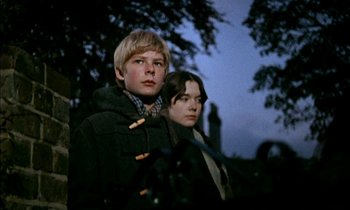 Movie still from “Our Mother's House” (1967), directed by Jack Clayton – A man and a woman standing next to each other in front of a tree; Medium shot, Low angle