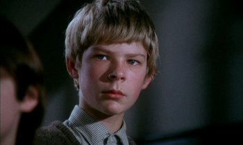 Movie still from “Our Mother's House” (1967), directed by Jack Clayton – A young boy with a sweater and a tie; Close Up shot, Low angle
