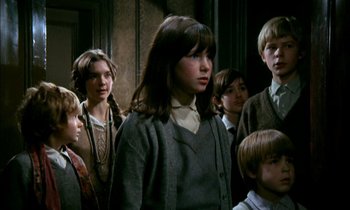 Movie still from “Our Mother's House” (1967), directed by Jack Clayton – A group of young people standing next to each other in a room; Medium shot, Low angle