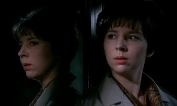 Movie still from “Our Mother's House” (1967), directed by Jack Clayton – A woman looking at her reflection in a mirror; Close Up shot, Low angle