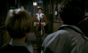Movie still from “Our Mother's House” (1967), directed by Jack Clayton – A man in a brown coat and a hat; Medium shot, Over the shoulder angle