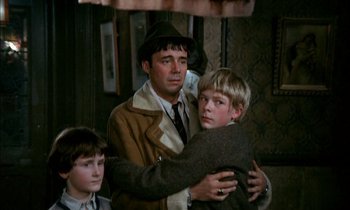 Movie still from “Our Mother's House” (1967), directed by Jack Clayton – A man and two young boys in a room; Medium shot, Over the shoulder angle