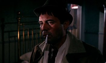 Movie still from “Our Mother's House” (1967), directed by Jack Clayton – A man wearing a hat and smoking a cigarette; Close Up shot, Low angle