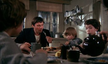 Movie still from “Our Mother's House” (1967), directed by Jack Clayton – A group of people sitting around a table eating food; Medium shot, High angle