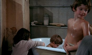Movie still from “Our Mother's House” (1967), directed by Jack Clayton – Two young children playing in a bath tub; Medium shot, High angle