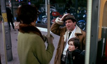 Movie still from “Our Mother's House” (1967), directed by Jack Clayton – A group of people standing next to each other on the street; Medium shot, Over the shoulder angle