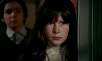 Movie still from “Our Mother's House” (1967), directed by Jack Clayton – A young girl with long dark hair and blue eyes looking at the camera; Close Up shot, High angle