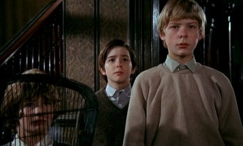 Movie still from “Our Mother's House” (1967), directed by Jack Clayton – Two young boys standing next to each other in front of a wall; Medium shot, Low angle