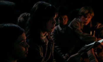 Movie still from “Our Mother's House” (1967), directed by Jack Clayton – A group of people sitting in a dark room; Medium shot, Over the shoulder angle