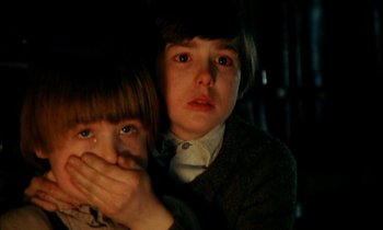 Movie still from “Our Mother's House” (1967), directed by Jack Clayton – A boy and a little girl covering their faces; Close Up shot, High angle