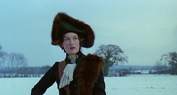 Movie still from “Out of Africa” (1985), directed by Sydney Pollack – A woman wearing a fur hat and a fur coat; Medium shot, Over the shoulder angle