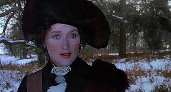 Movie still from “Out of Africa” (1985), directed by Sydney Pollack – A person wearing a hat with fur; Close Up shot, Over the shoulder angle